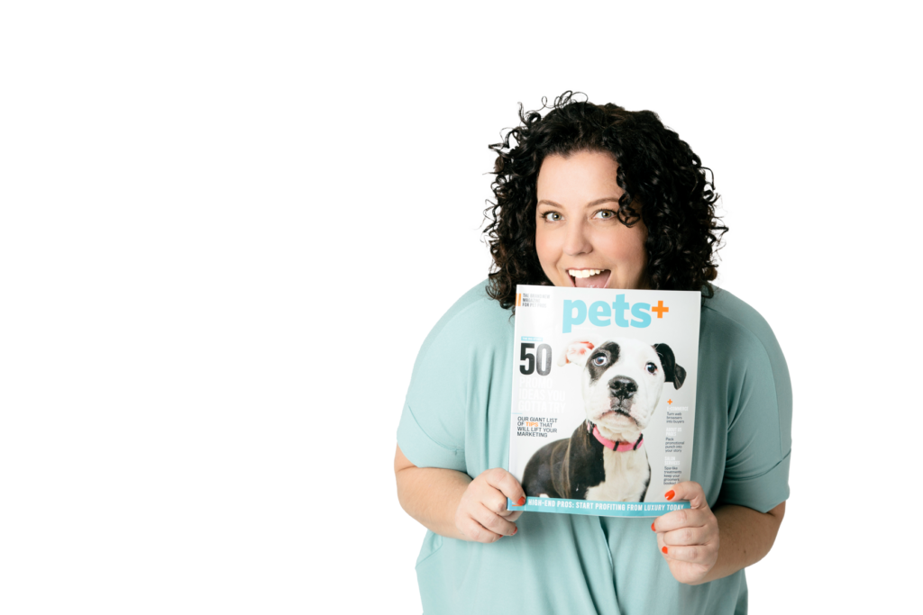 Founder of Pet Boss Nation holding Pets+ Magazine