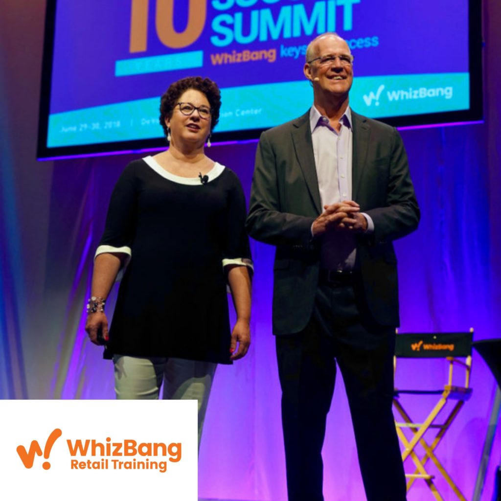 Whizbang representatives standing on a stage